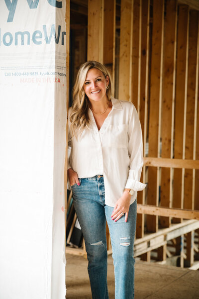 Erica holding a cup of coffee in one of their newly remodeled kitchens.