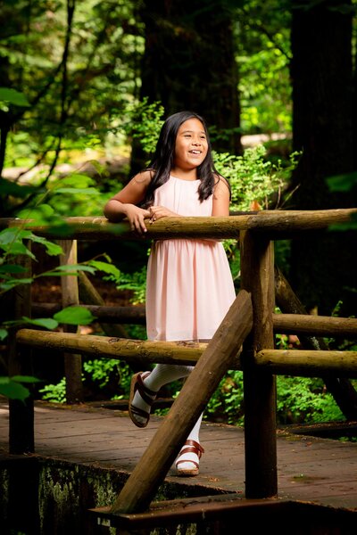 girl smiling on a bridge