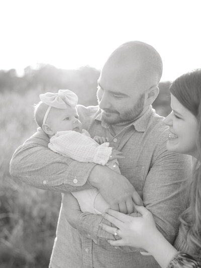 Parents gazing lovingly at their newborn baby, capturing a tender family moment filled with joy and connection. This beautiful image showcases the bond between parents and their new child