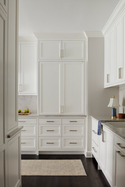 Bright white kitchen with dark wood flooring