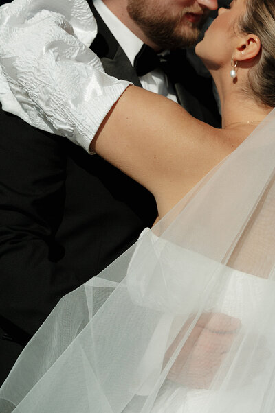 Bride and groom share a candid moment after pouring champagne at their wedding reception