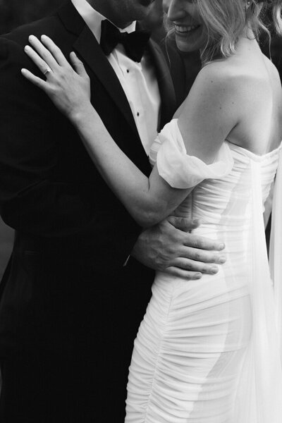 bride and groom holding each other