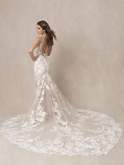 We adore the gorgeous contrast between a demure high neckline and long sleeves paired with a jaw-dropping open back.