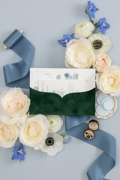 Montana wedding invitations in a custom green velvet pocket, blue silk ribbon, vintage stamps by Seventh and Anderson