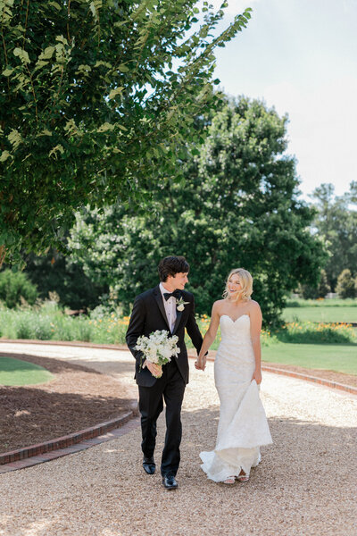Bride and groom share a tender embrace in a sunlit garden, capturing a timeless and romantic moment.