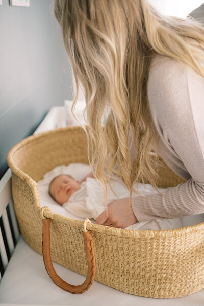 mom picking up baby during newborn session