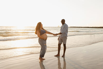 maternity photo on beach mom and dad dancing