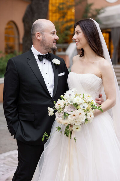 Bride and groom portraits at Rosewood Mansion on Turtle Creek, with the bride in a tulle ballgown and the groom in a tuxedo