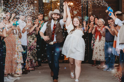 Lacey Nicole Photography at The Rosewood Venue in Mount Vernon Texas Bride and Groom Grand Exit at wedding reception with wedding party bubble exit