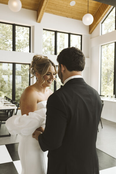 bride and groom kissing by array of flowers