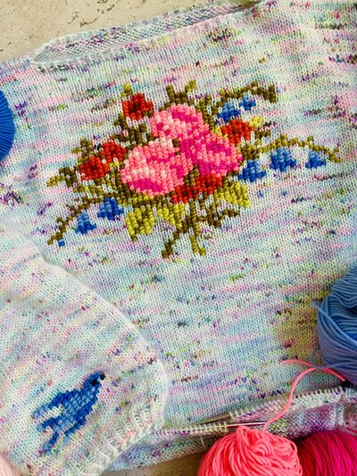 Crochet snowflake mandala on a blue rustic background.