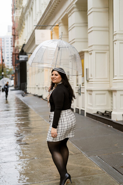 woman walking away while holding an umbrella