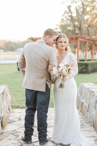 Couple kissing at their engagement session in a beautiful garden