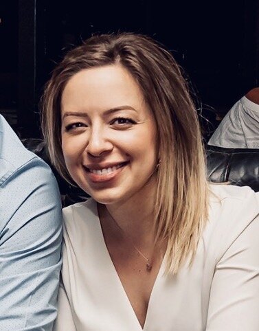Image of Kristen, the owner of The Beautifully Well. Kristen is smiling in a cropped photo