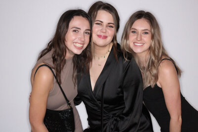 Three friends taking a picture at an event in Vancouver