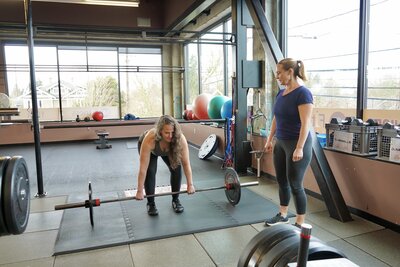 woman demonstrating form  to client 3