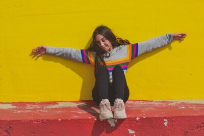 teen sitting against the wall