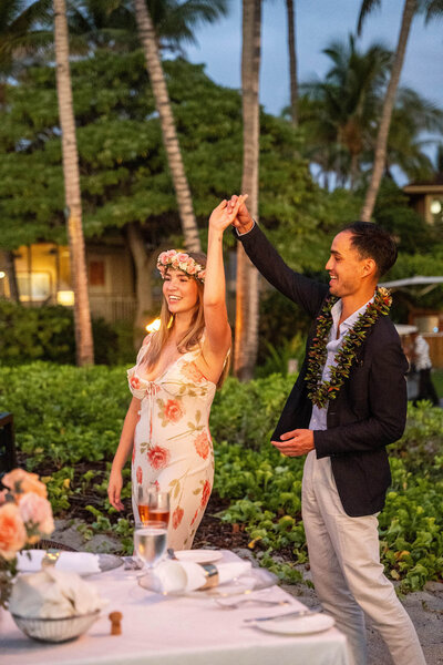 Couple dancing together during a romantic dinner under the stars at the Four Seasons Hualālai, photographed by Hawaii Adventure Portraits, a Big Island proposal photographer