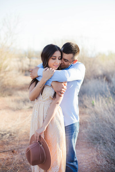 couple hugging during outdoor engagement session