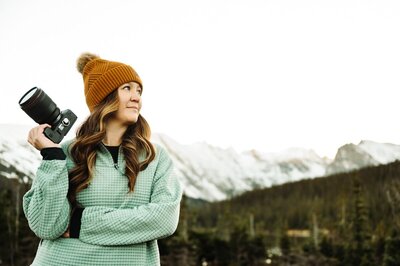 Denver Elopement Photographer captures woman holding camera before capturing Colorado microweddings