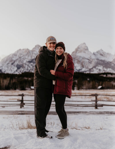 Lauren and Matt of Intimate Adventures Media standing in front of the Grand Teton in Grand Teton National Park