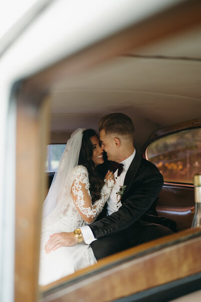 bride and groom in vintage car