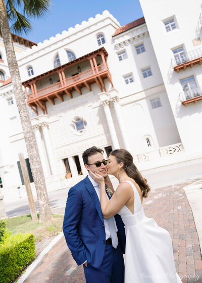 A bride and groom kiss at their St. Augustine wedding