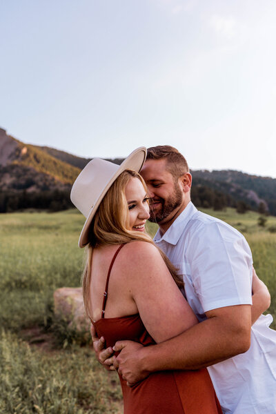 couple holding each other in field