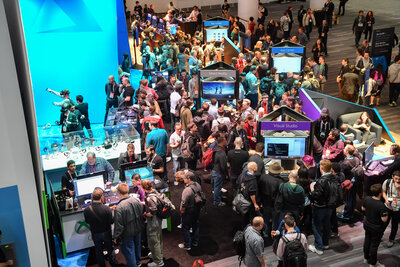 Crowd of people at a technology convention, engaging with booths and displays.