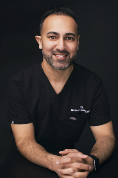 Board-certified physician Dr. Syed explaining personalized filler options to client