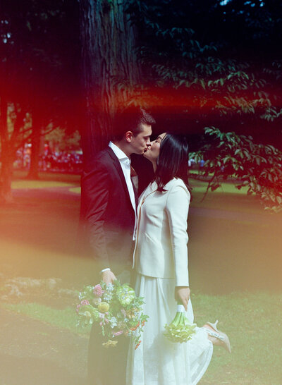 couple in boston public garden holding hands for elopement portraits on black and white medium format film 