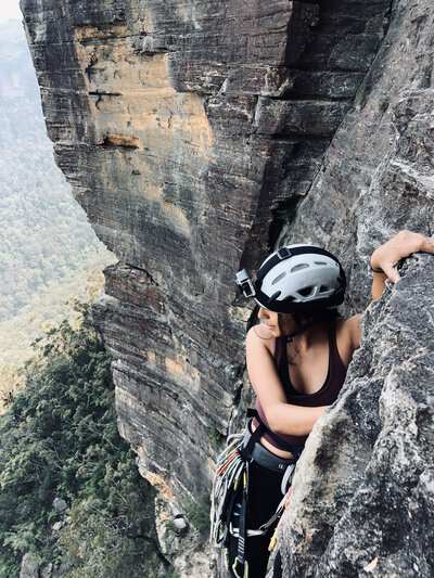 woman climbing a mountain