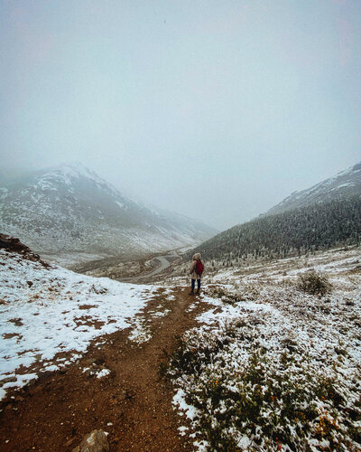 Woman on Alaska hiking trail in winter snow