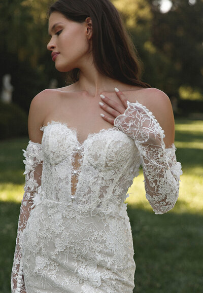 Bride in wedding dress smiling by the window