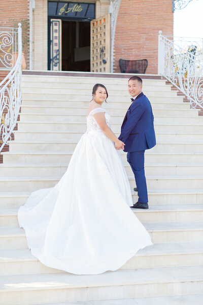 bride and groom walking on stairs
