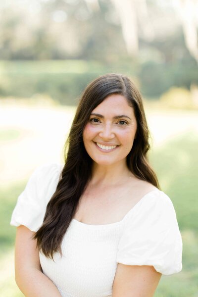 A woman from Lamp and Light Photography by Danielle Puckhaber, smiling at the camera in Palmetto Bluff in Bluffton, South Carolina taken by Hilton Head Photographer.