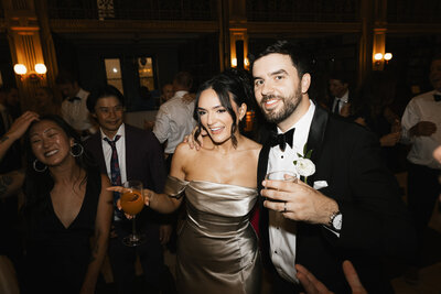 stylish bride and groom with a cocktail during the reception