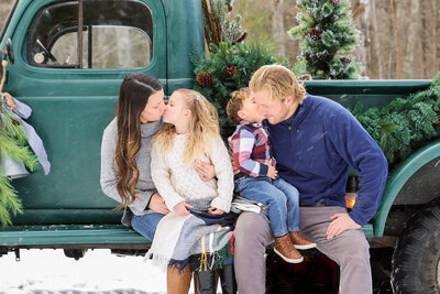 Family photo in front of green truck with everyone sitting | Family Photo Session