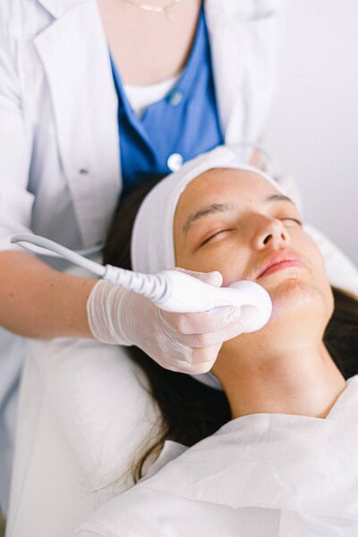 women on a table getting a laser treatment