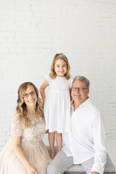 Functional Medicine Practitioner, Carolyn Teague, smiles with her daughter and husband
