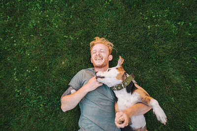 man-playing-with-dog-in-poop-free-backyard