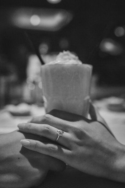 Couple holding hands at a diner