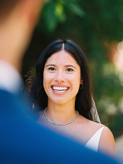 Bride smiles warmly at her groom during their first look moment at Casa Colonial Beach & Spa photographed by Asia Pimentel, fine art wedding photographer.