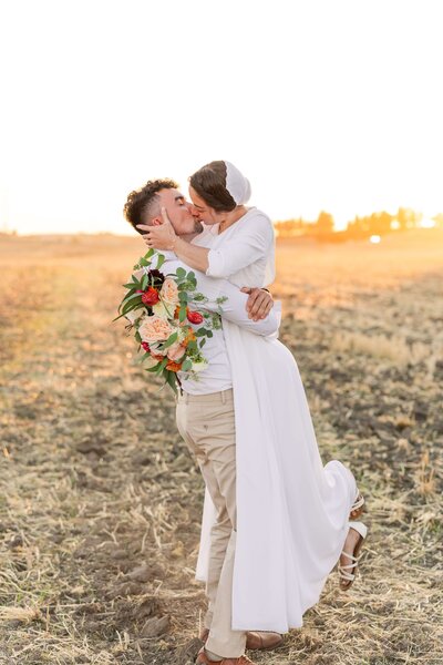 Bride & Groom kiss in the sunset - Fall Idaho Wedding