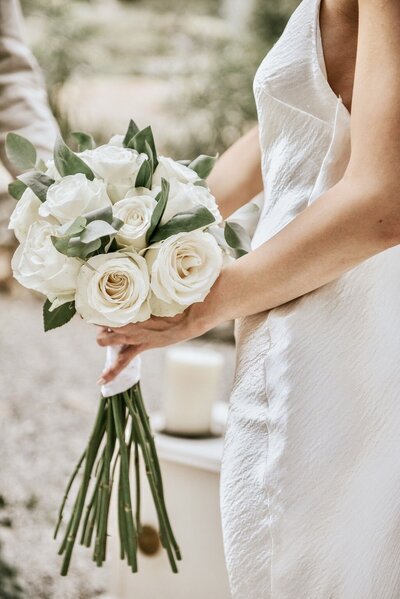 Close-up of a white rose bridal bouquet, styled for an elegant Ionian wedding with timeless floral design.