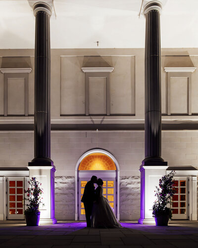 The Palace at Somerset Park | Lebanese bride and groom silhouette kissing between pillars during wedding night photo | Somerset, New Jersey