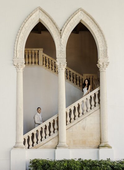 bride and groom pose on stairwell