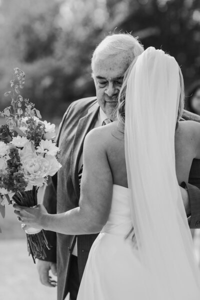 Bride hugging her father during a wedding ceremony in St. Augustine.