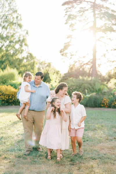 Fine art Catholic wedding photographers Laura and Matthew Schaefer with their children on the beach