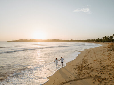 bride and groom walking on beach